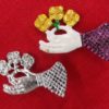 Hand Holding a Flower Brooch