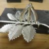 Casting of the English rose brooch with part of the mold