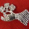 Hand Holding a Flower Brooch - Image 3