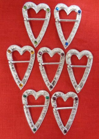 selection of heart shaped ring brooches with stones