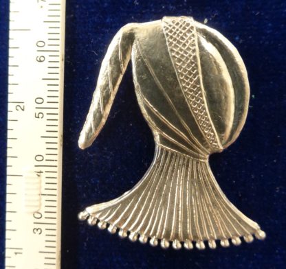 Butt hood brooch with a scale
