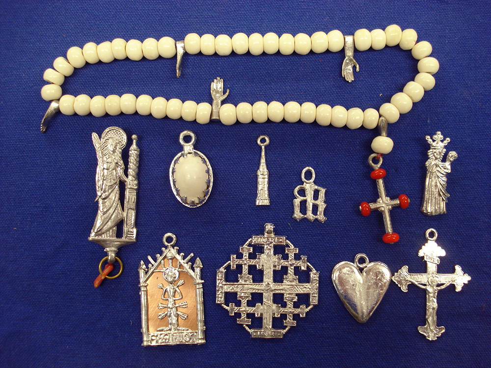 Rosary of bone beads with a selection of pendant saints' signs