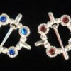 Cock ring brooches, blue and red