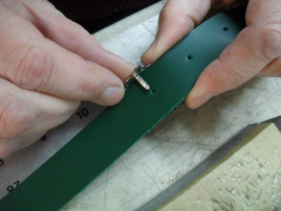 pressing studs into prepared holes