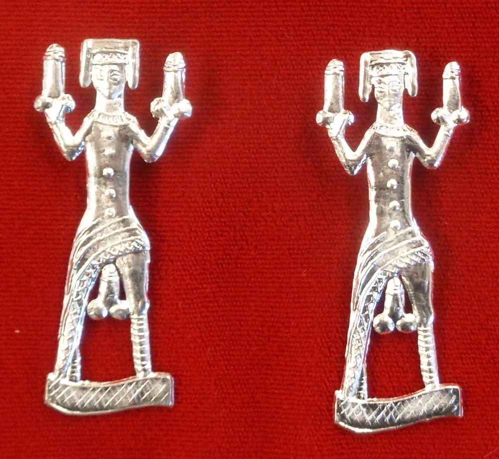 Two in the Hand Brooch - a woman holding a penis in each hand, and with another between her legs.