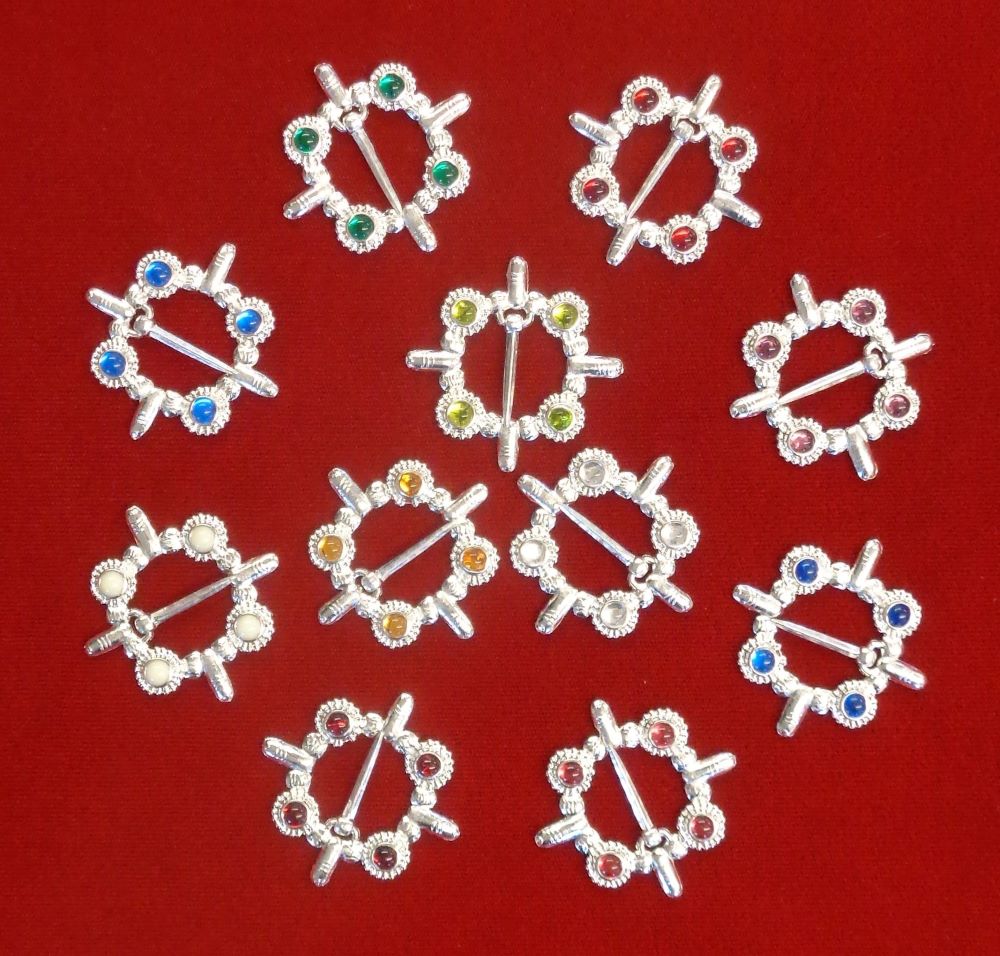 A selection of cock ring brooches, with stones of different colors.