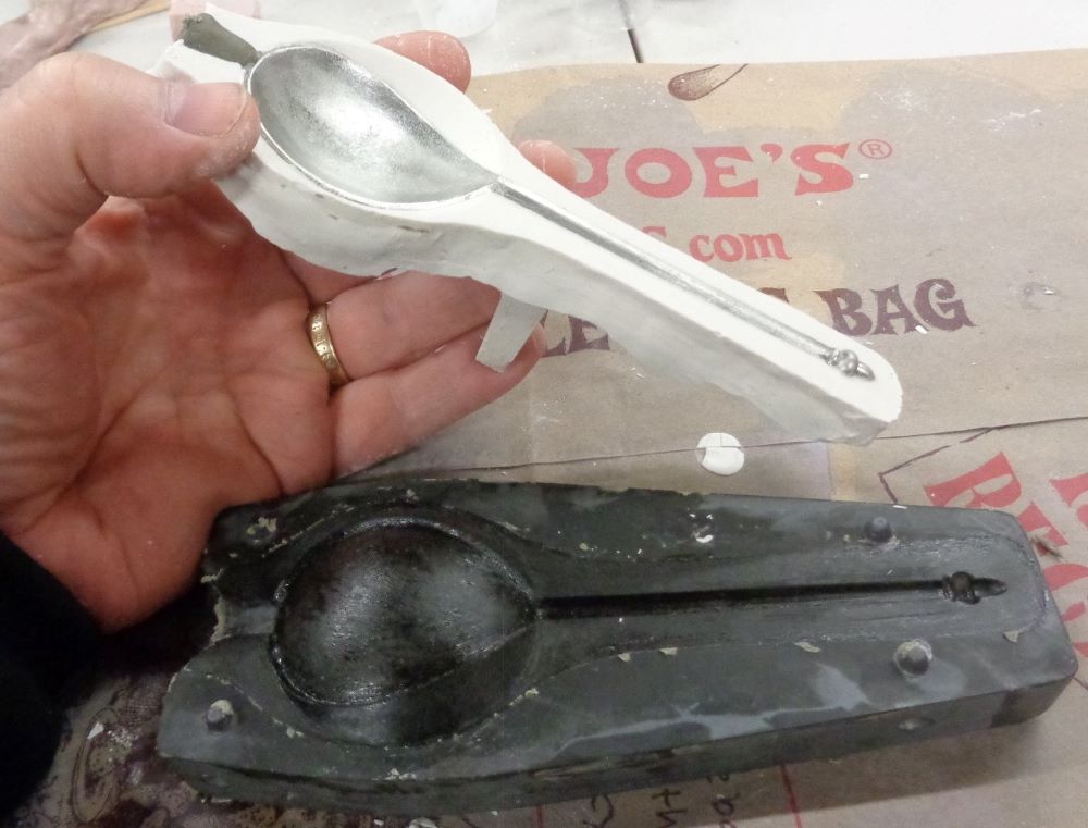 Pattern for half the mold with spoon embedded, built up on stone mold