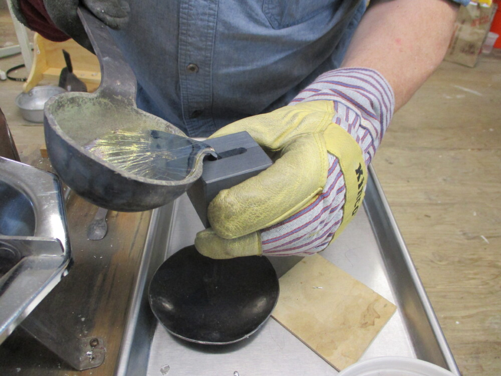 Filling the rumbler bell mold.