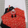 Contents of a kit to make a small purse in red and gold brocade