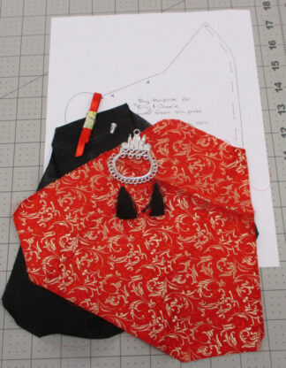 Contents of a kit to make a small purse in red and gold brocade