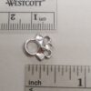 A pointy eyelet shown next to imperial and metric scales.