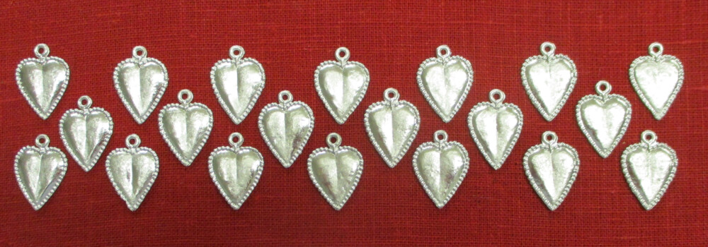 An array of heart spangles on a red background