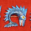 3 dolphin badges painted blue