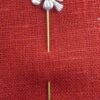 A veil pin with a pelican in its piety as a head