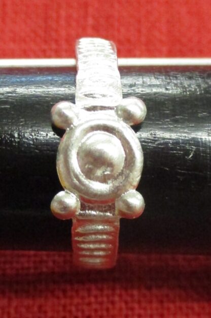 Ring 1, a single false stone setting, with four small dots adjacent to the central element