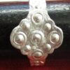 Ring 3, wiht a quatrefoil decorated with dots