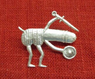 Brooch of a penis with legs, holding a sword above his head and presenting a buckler below