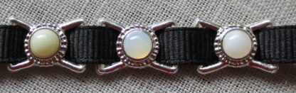 three chaplet decorations with stones, showing the choices among the white stones