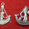 Two pewter objects with related iconography. The first shows a boat with the Virgin Mary with crown and halo holding the Christ child in one arm and steering the boat the a rudder with the other. The second shows a crowned woman in a boat holding a crowned penis in one hand and with the other hand on a penis that serves as a rudder.