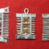 Three similar pendant combs with differing decoration in the middle between the teeth: the first with a scene of heterosexual intercourse; the second with an openwork decorative design; the third with a number of penises arranged along a ribbon