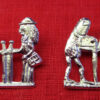 Two brooches showing a male and female pilgrim. One has human figures; in the other the pilgrims are a penis and a vulva.
