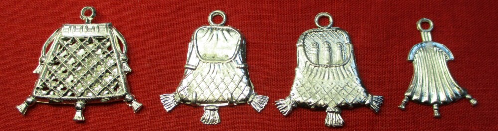 Three similar pendant purses. The first is an openwork drawstring purse and contains a pretend coin. The second looks like a closed frame purse on one side; the other side reveals it contains three penises. The third is a small, closed frame purse.