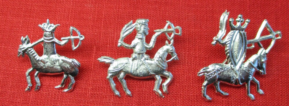 Three similar figures on horseback carrying crossbows. The riders are a penis, a man, and a vulva