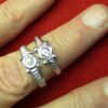 Two similar rings, one with a pretend stone setting, the other with a vulva.
