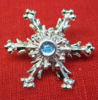 Snowflake brooch with aqua glass stone