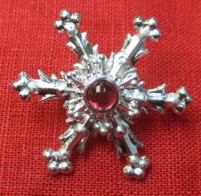 Snowflake brooch with rose glass stone