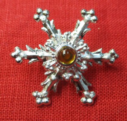 Snowflake brooch with yellow glass stone