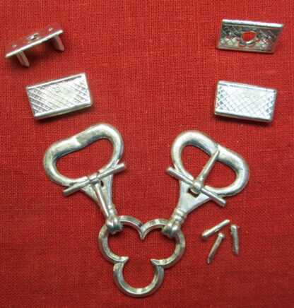 Two buckles joined by a trefoil, two eyelets, two chapes, and three rivets