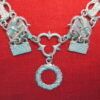 Close up of buckles for livery collar of links, with the circular pendant with a twist.