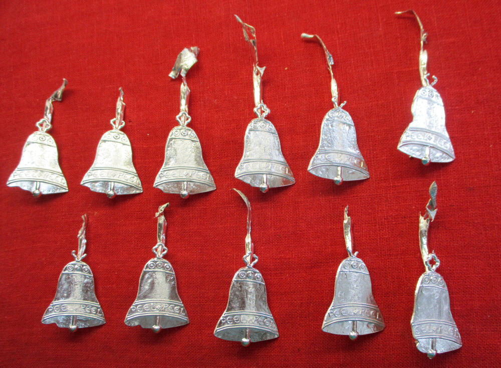 Array of bells with casting failures, complete with sprues