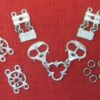 Buckles linked to trefoil, chape and eyelet segments, three links wiht sotnes, and two sizes of jump rings, from the livery collar of links