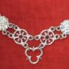 detail of the links with stones alternating with roses, together with a trefoil pedant holder
