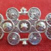Front of cloak clasp with 13 rondels decorated with different patterns