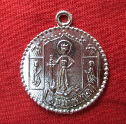 Round pewter badge for St. Dymphna with the saint in the middle under an arch, holding a sword above the head of a demon under her feet.