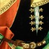 Bee-shaped lacing eyelets at the neck opening of a cote.