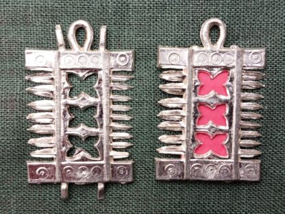 The comb pendant, shown with no backing and with a paper backing
